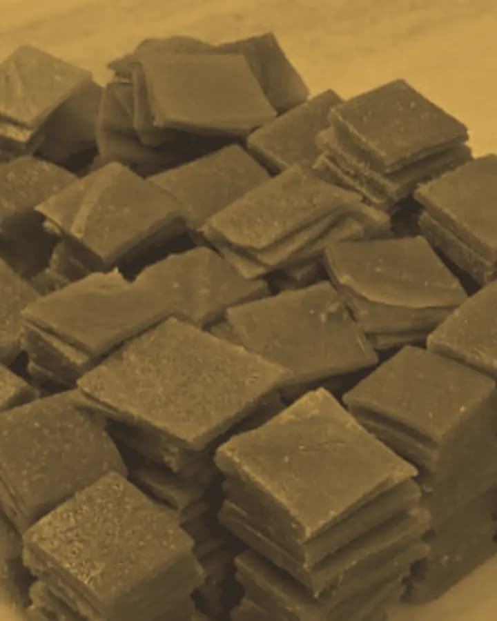 Hand-cut squares of sun-set aam papad in basalt-and-gold duotone