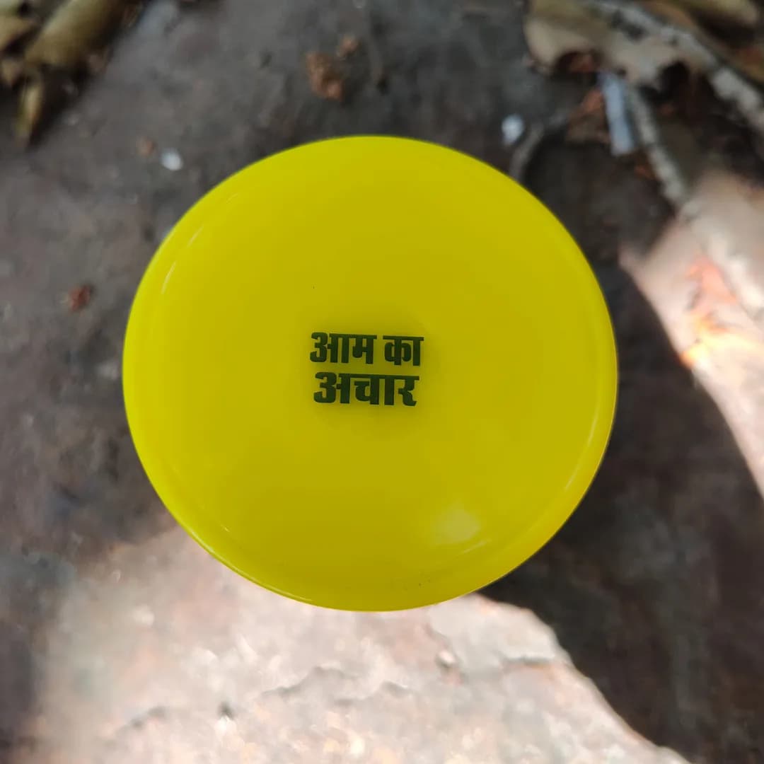 A sealed jar lid stamped with the product name in Hindi
